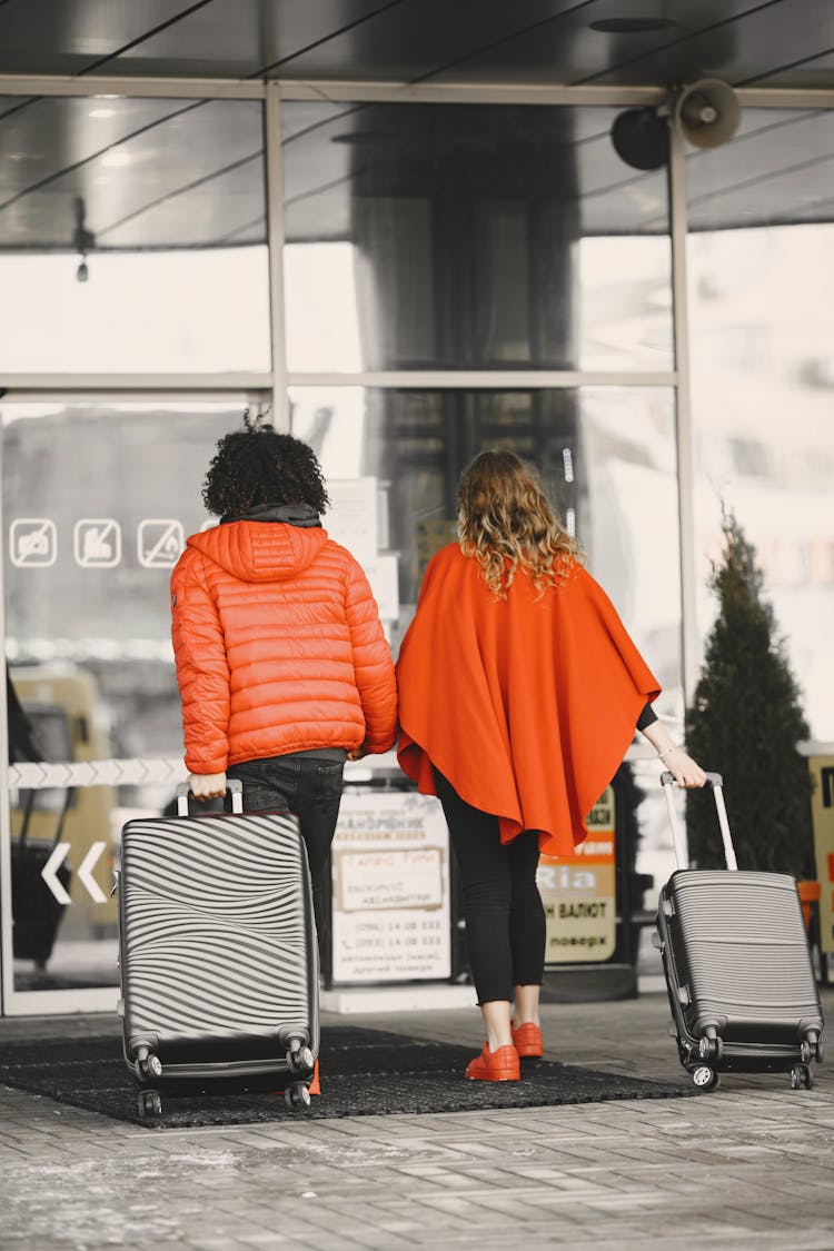 Back View Of A Couple Pulling Luggages