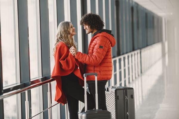 Travellers with luggage in an airport terminal, photo by Gustavo Fring on Pexels