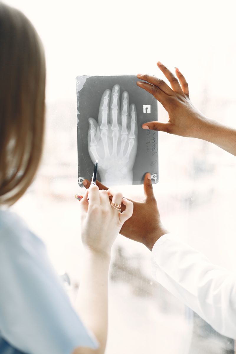 Clinicians analyzing a hand X-ray in a medical clinic