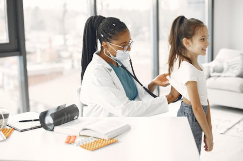 Free A Doctor Checking-up the Girl Using Stethoscope Stock Photo