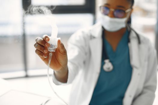 Close-Up Photo of a Healthcare Professional Holding a Nebulizer