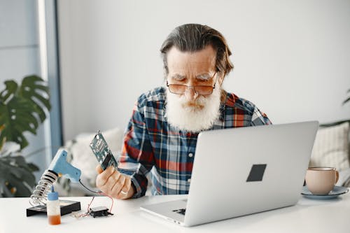 Close-Up Shot of a Bearded Man in Checkered Long Sleeve