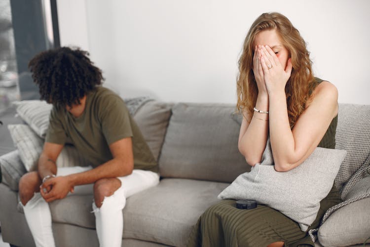 A Distant Couple Sitting On A Sofa