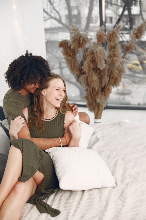 Free A Happy Couple Sitting on the Bed Stock Photo