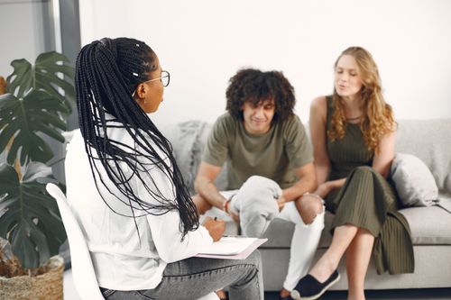 Free A couple at a therapy session discussing issues with a professional counselor. Stock Photo