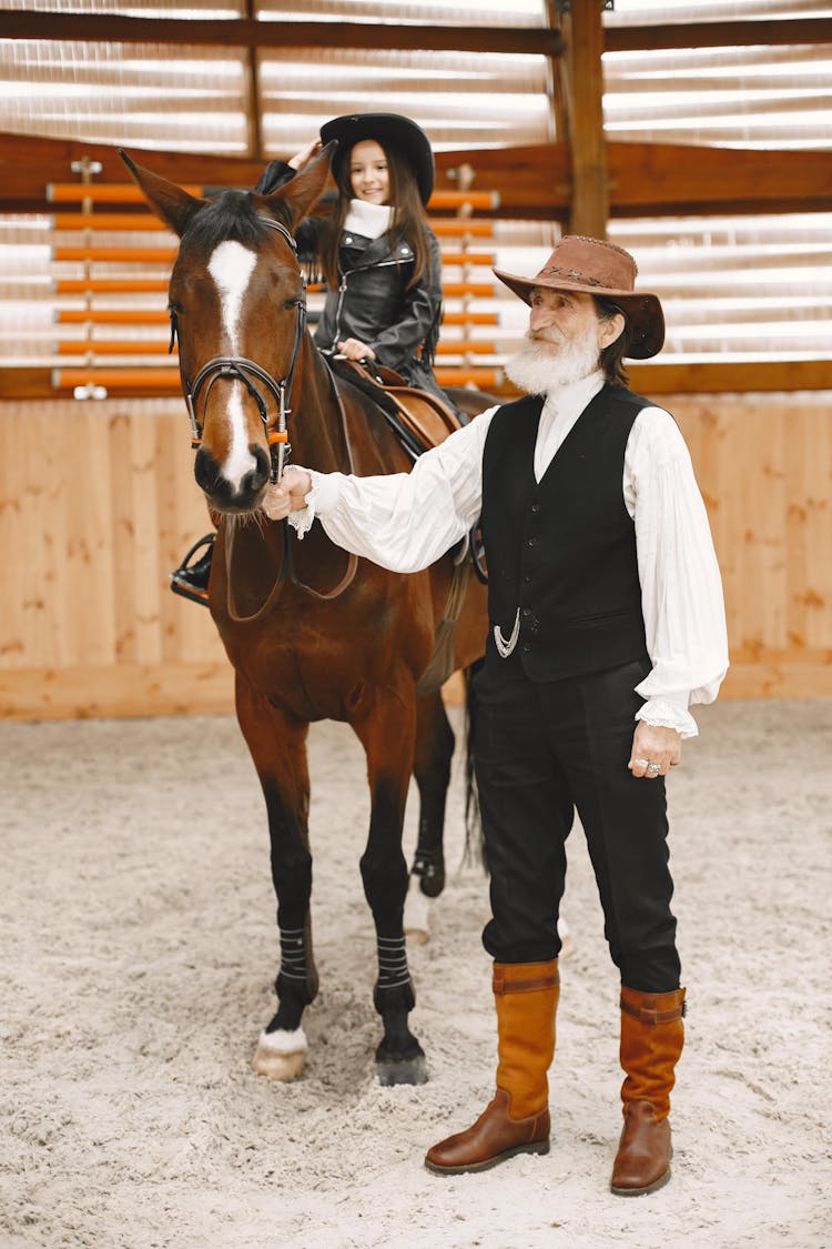 A Young Cowgirl Riding A Horse