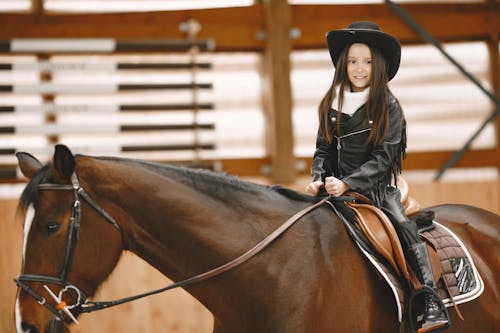 Little Girl Horseback Riding and Smiling 