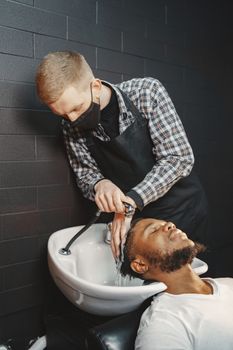 Hairdresser washing client's hair at a salon with care and precision.