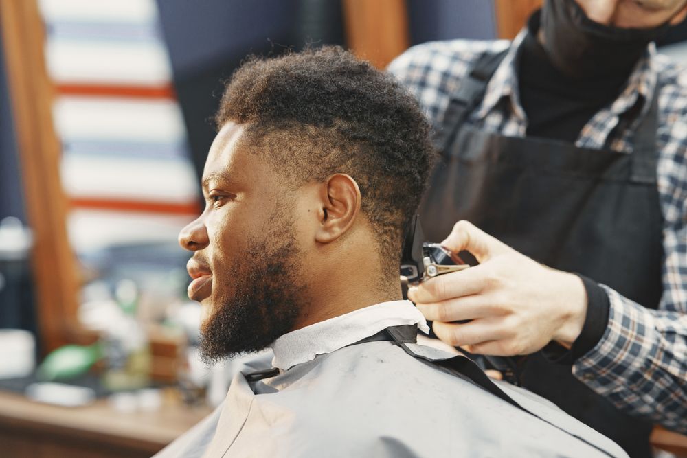 Side view of a client receiving a haircut
