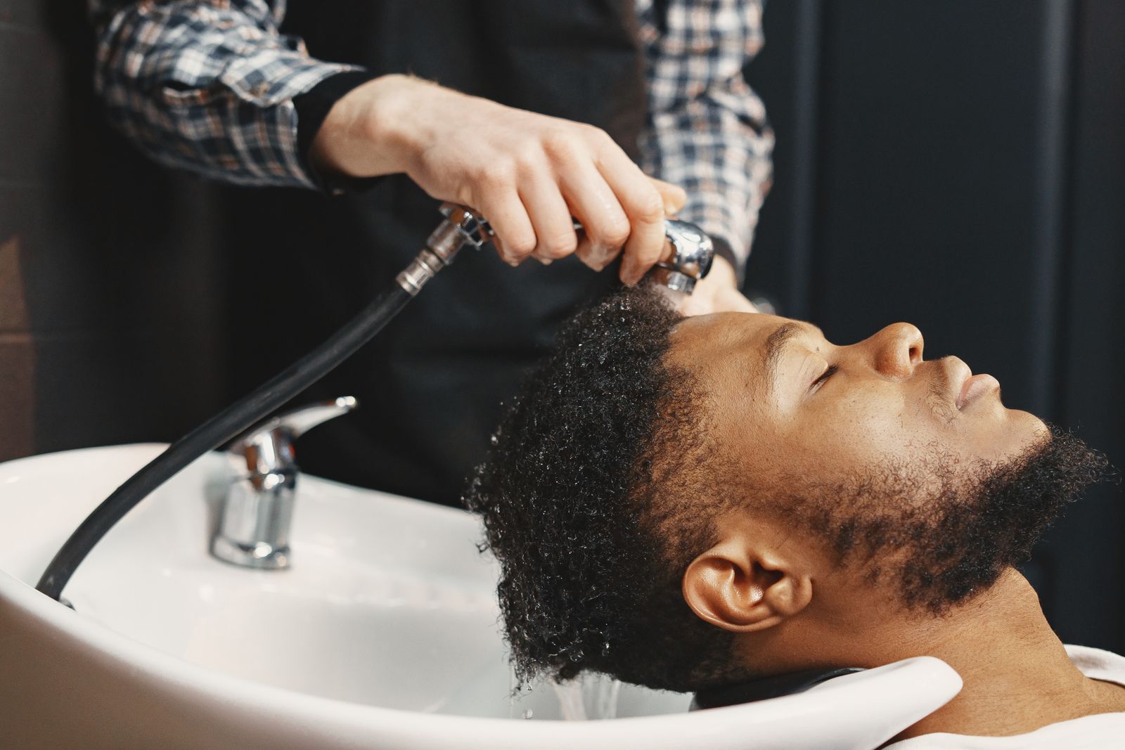 Man washing his hair with shampoo in the shower
