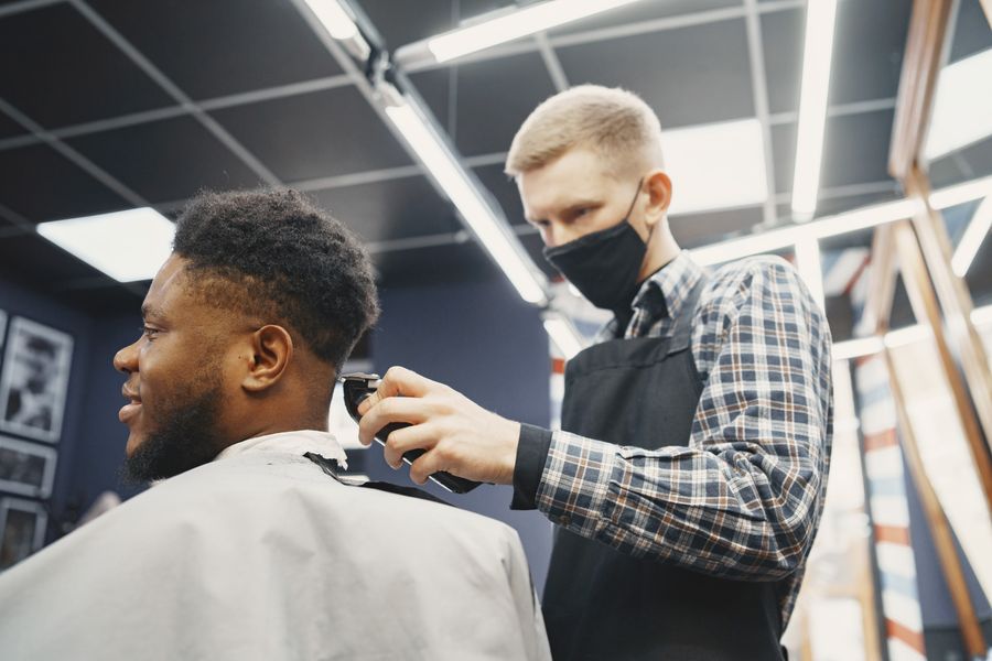 Specialist finishing a men's hair system