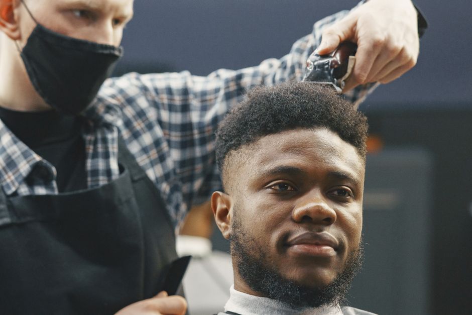 man receiving hair care instructions from professional stylist