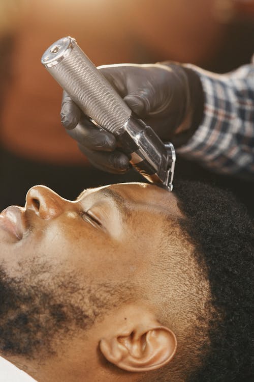 Close Up Photo of a Man Getting a Haircut