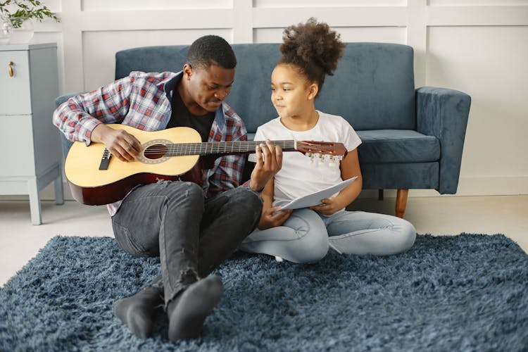 Father Playing Guitar With Daughter