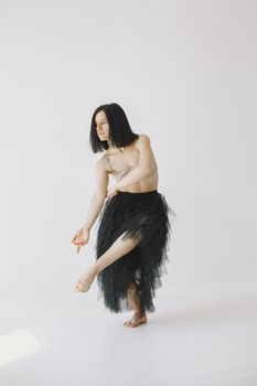 Elegant portrait of a dancer in studio capturing a moment of balance and poise.