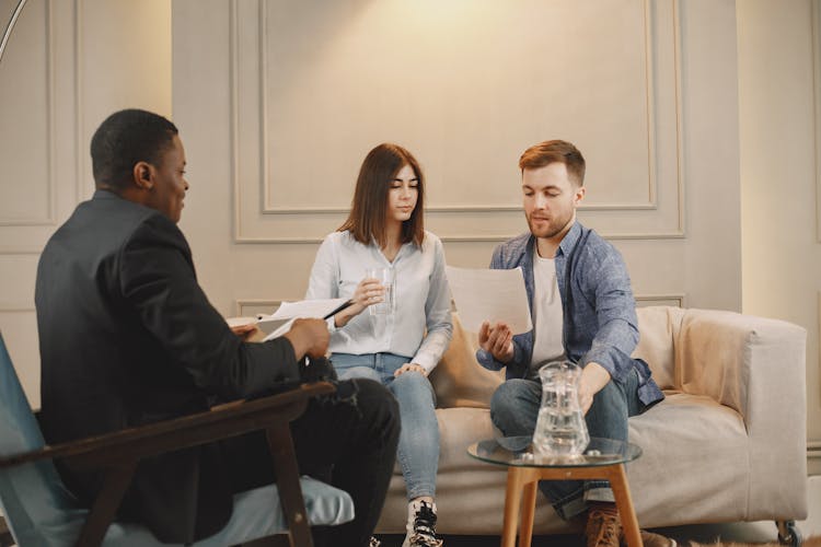 Couple Reading Documents From Therapist