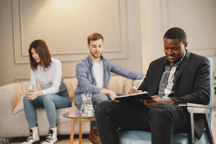 A Man Talking To A Couple