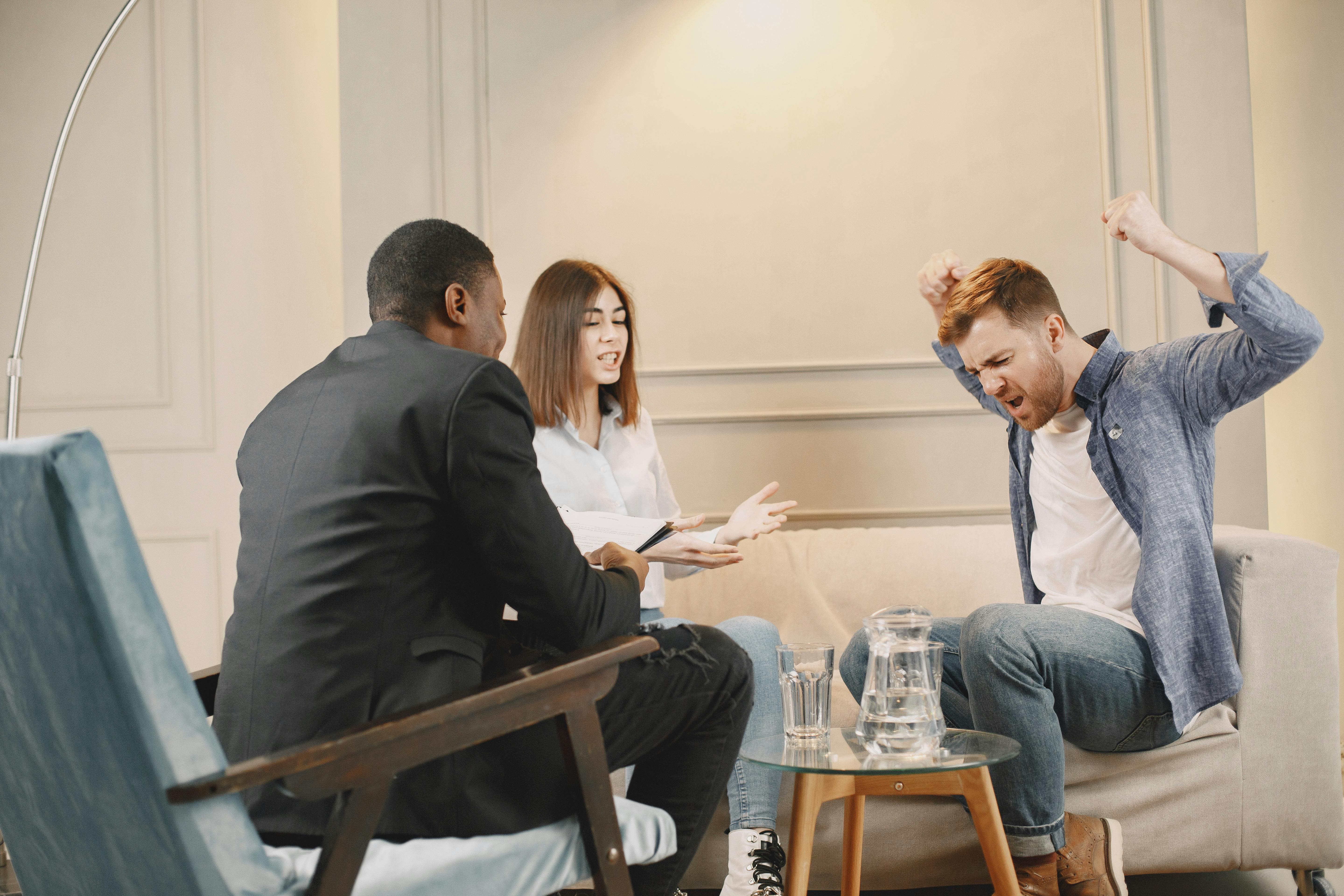 Photograph of a Couple Arguing Near a Therapist · best couples therapist