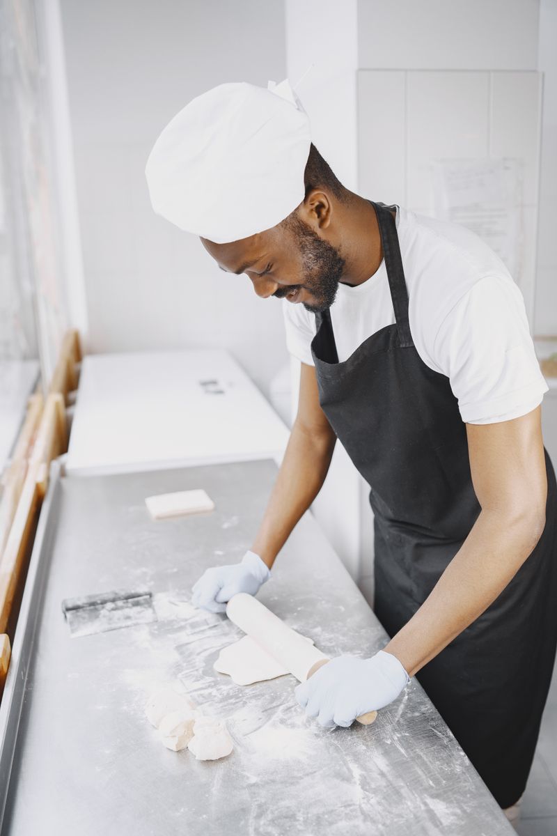 Baker shaping dough by hand