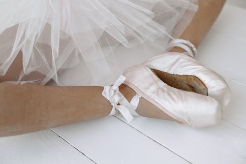 Photo of a Person Wearing Pink Ballet Shoes