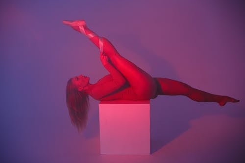 Woman Lying On A Box With Leg Raised 