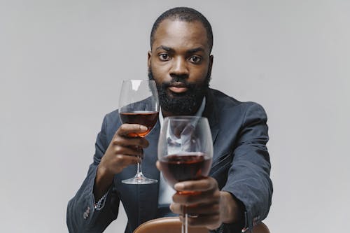 A Man Holding Wine Glasses 