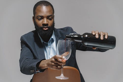 A Man Pouring Wine in a Glass