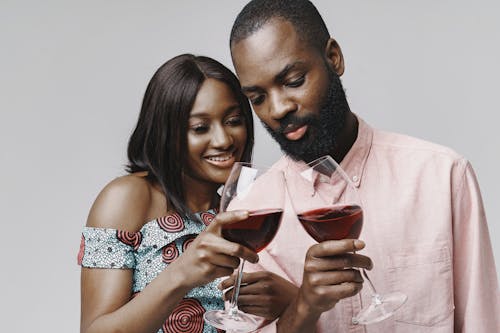 A Couple Holding Wine Glasses