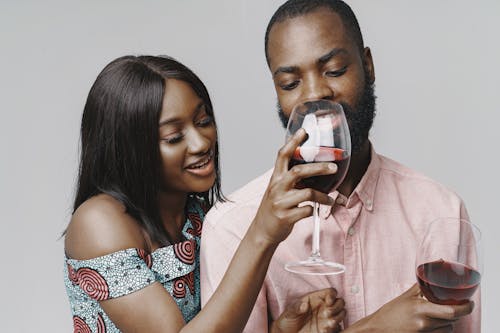 Woman Giving Man Taste of her Wine