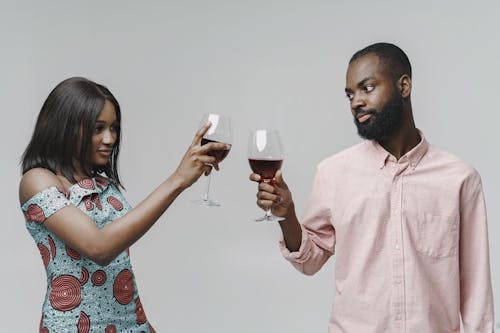 Man and Woman Toast Red Wine Glasses