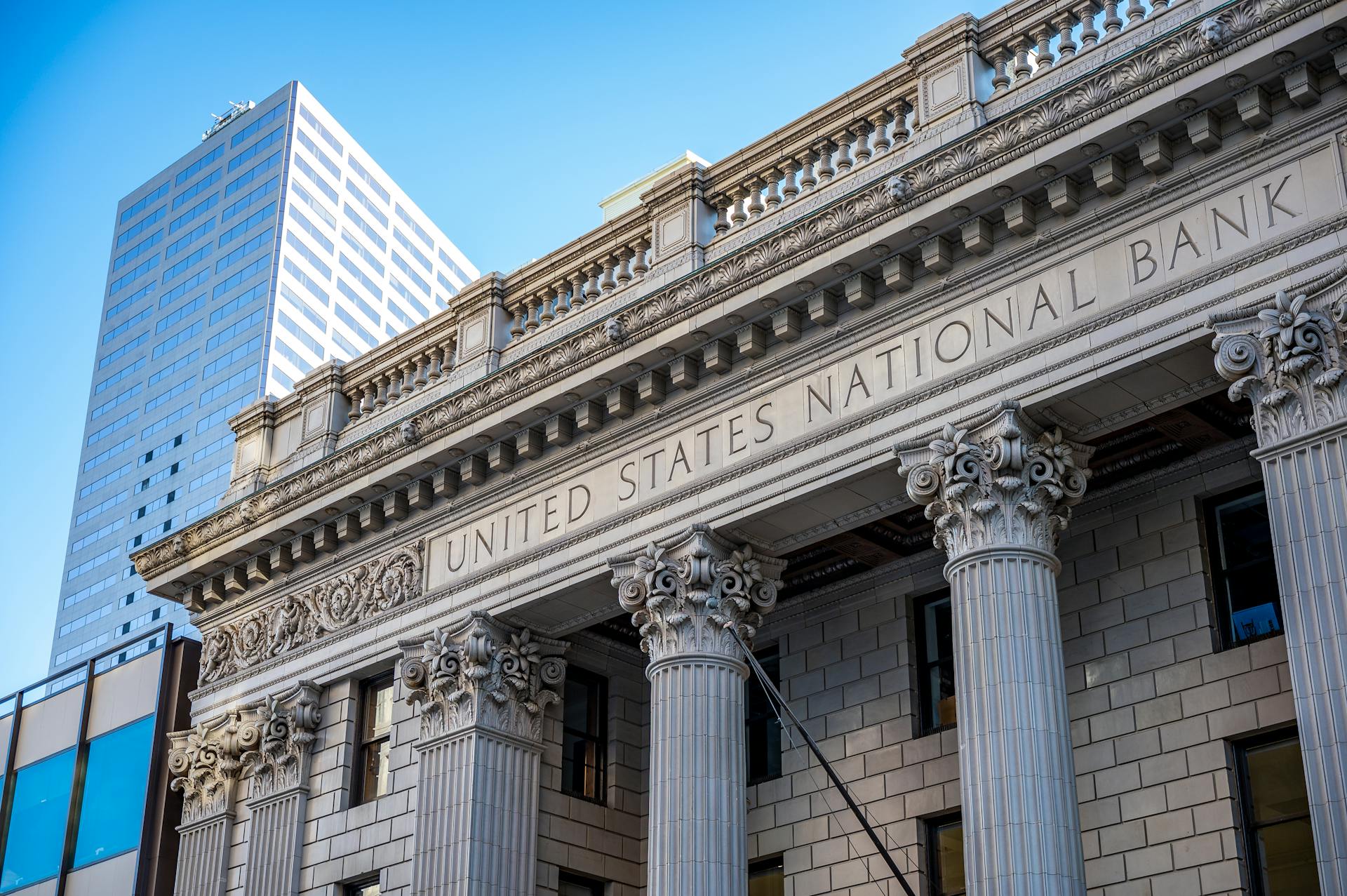 Close view of the United States National Bank building with classic columns and architecture.