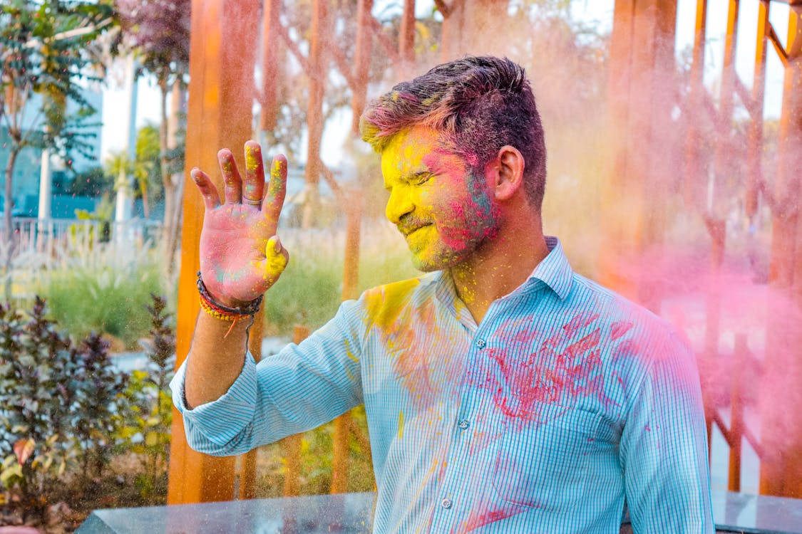 Free A Man with Colored Powders on His Hand and Face Stock Photo