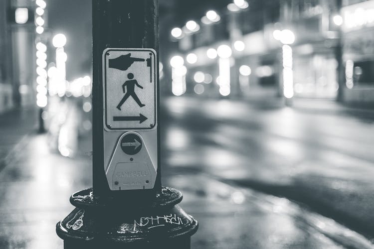 Pedestrian Crosswalk Button Placed Near Roadway In City In Evening Time