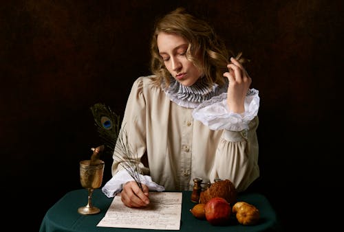 Free Close-Up Shot of a Woman Writing Stock Photo
