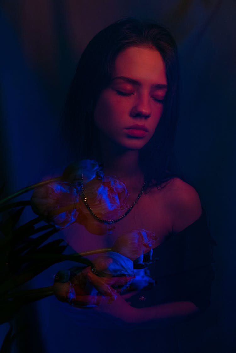 Mindful Model With Blooming Flowers In Neon Light