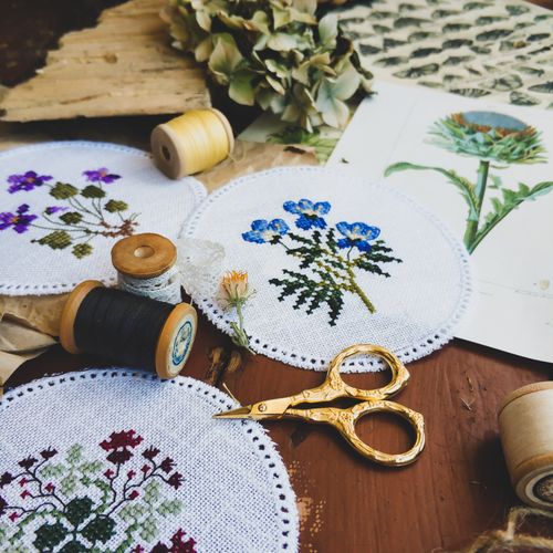 Free From above of assorted handmade embroidery made placed with threads and scissors for handicraft hobby Stock Photo