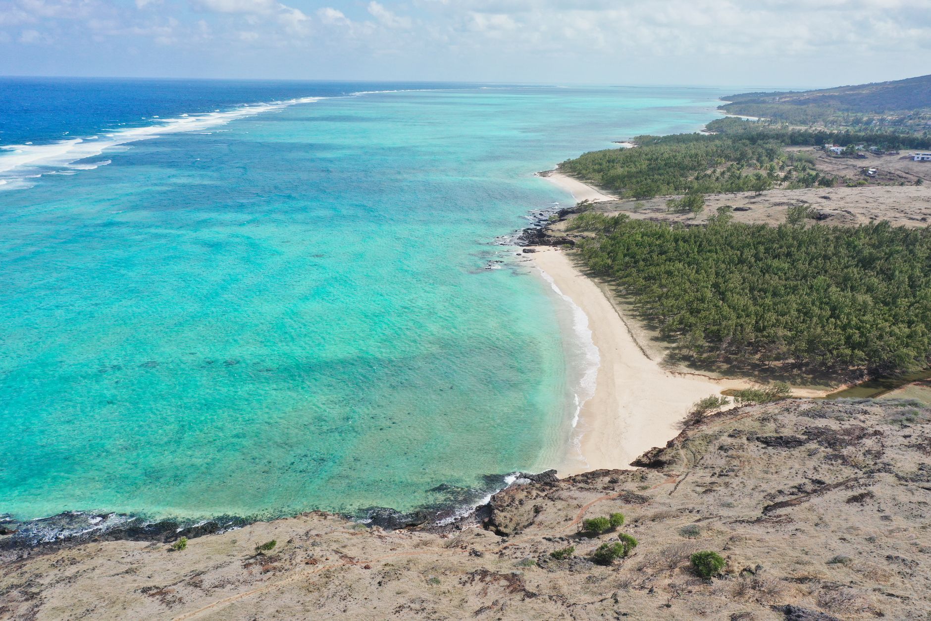 Explore the breathtaking aerial view of Gravier's coastline in Rodrigues, Mauritius, showcasing turquoise waters and sandy shores.