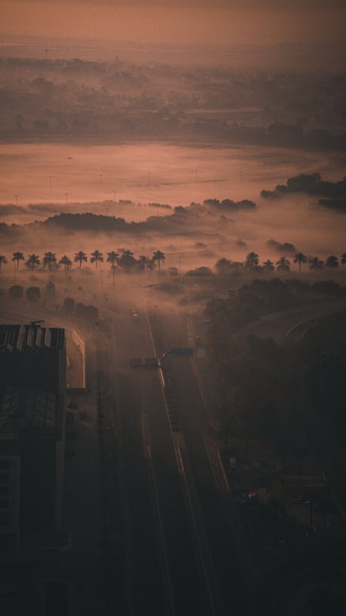 Aerial Shot of a City Covered in Fog at Dusk 