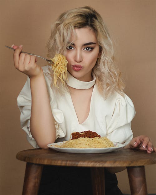 Blond Woman Eating Spaghetti with a Fork