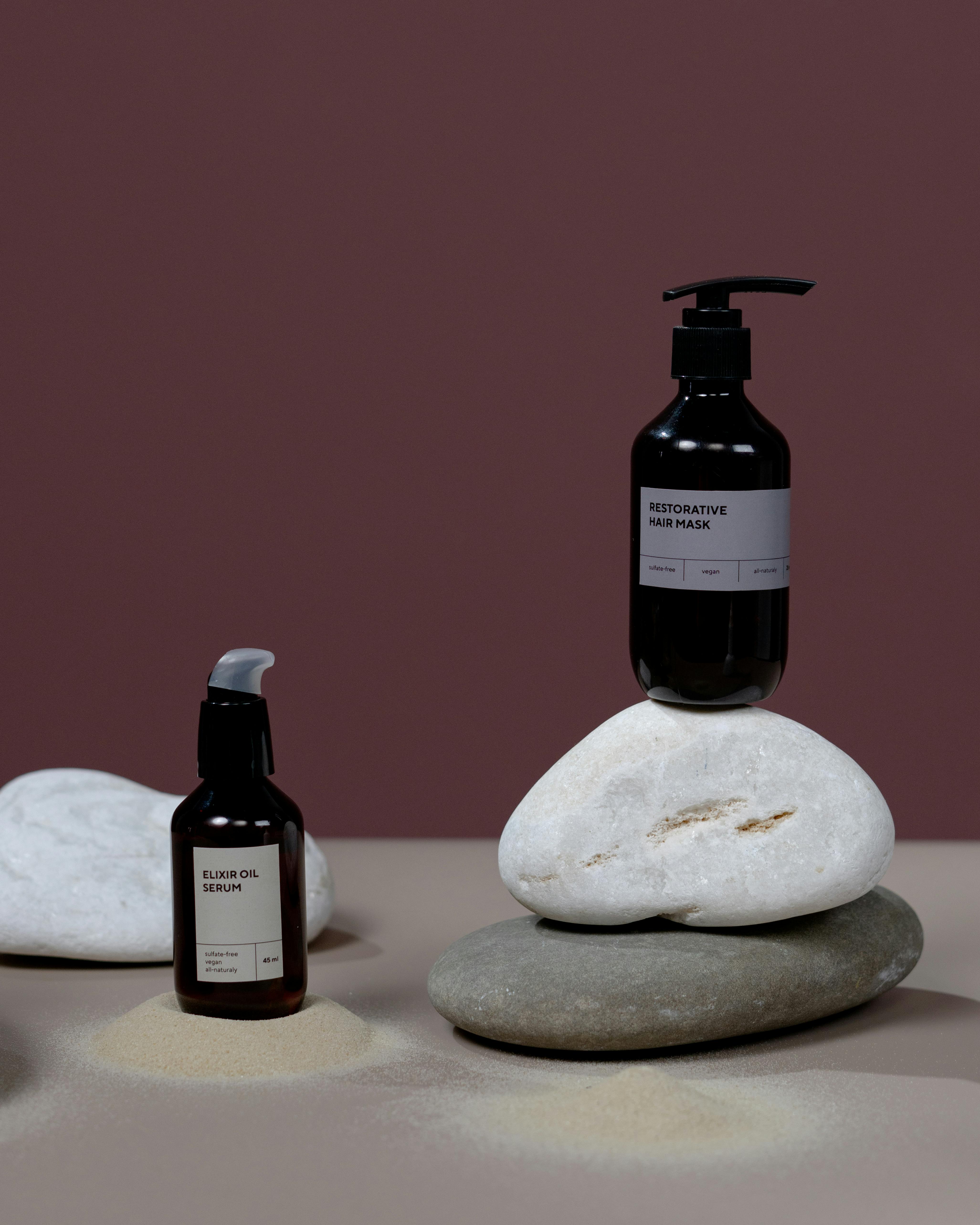 Studio shot of organic haircare products on stone with a minimalistic design.
