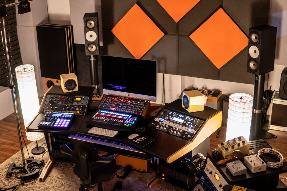 How White Noise Machines Like LectroFan Compare to Hatch Restore for Sleep A well-equipped music studio with audio mixers and monitors in a creative setup.