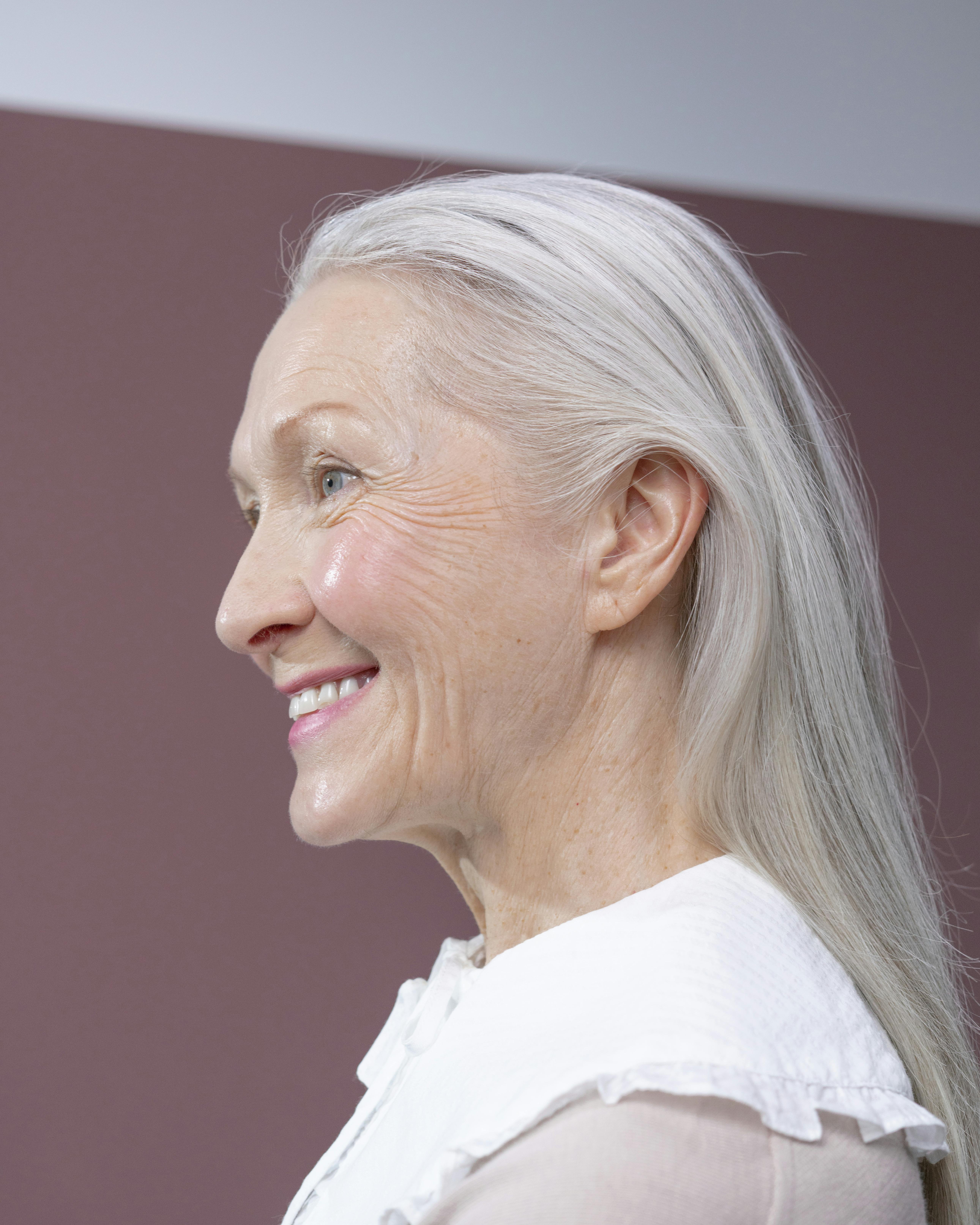 smiling woman with long straight gray hair