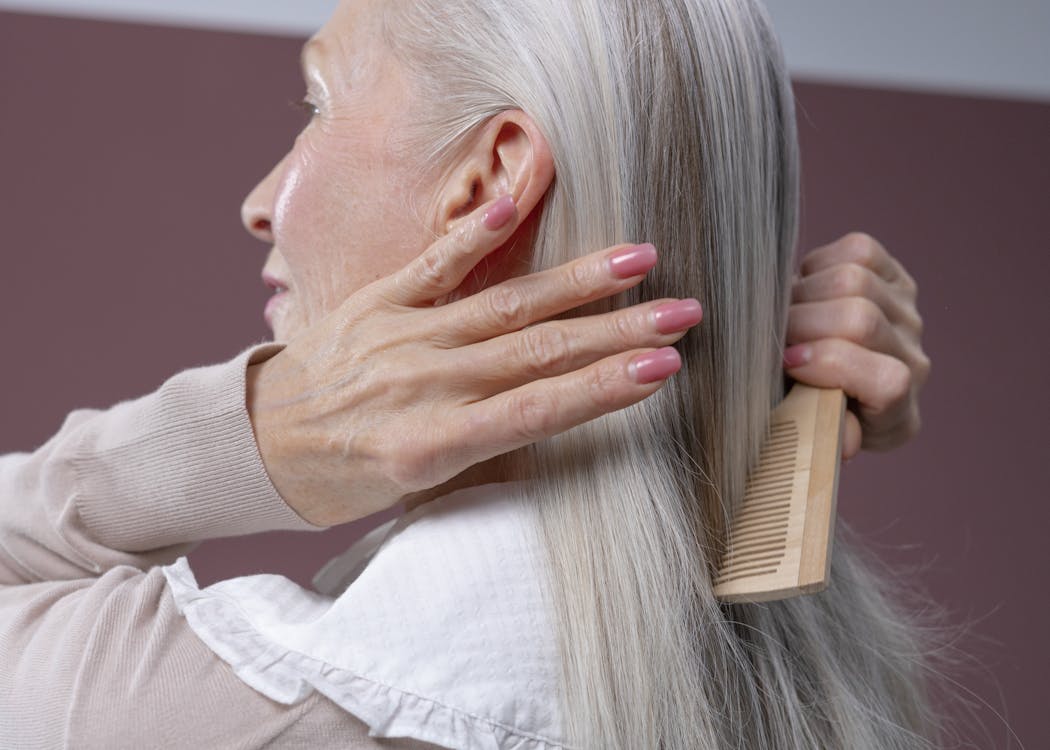 Free Elderly Woman Combing Her Hair Stock Photo