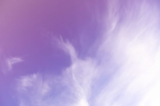 Photograph of a dreamy and dramatic cloudy sky with purple hues, perfect for scenic backgrounds.