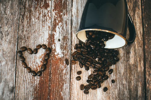 Free Black Ceramic Coffee Mug and Beans Stock Photo
