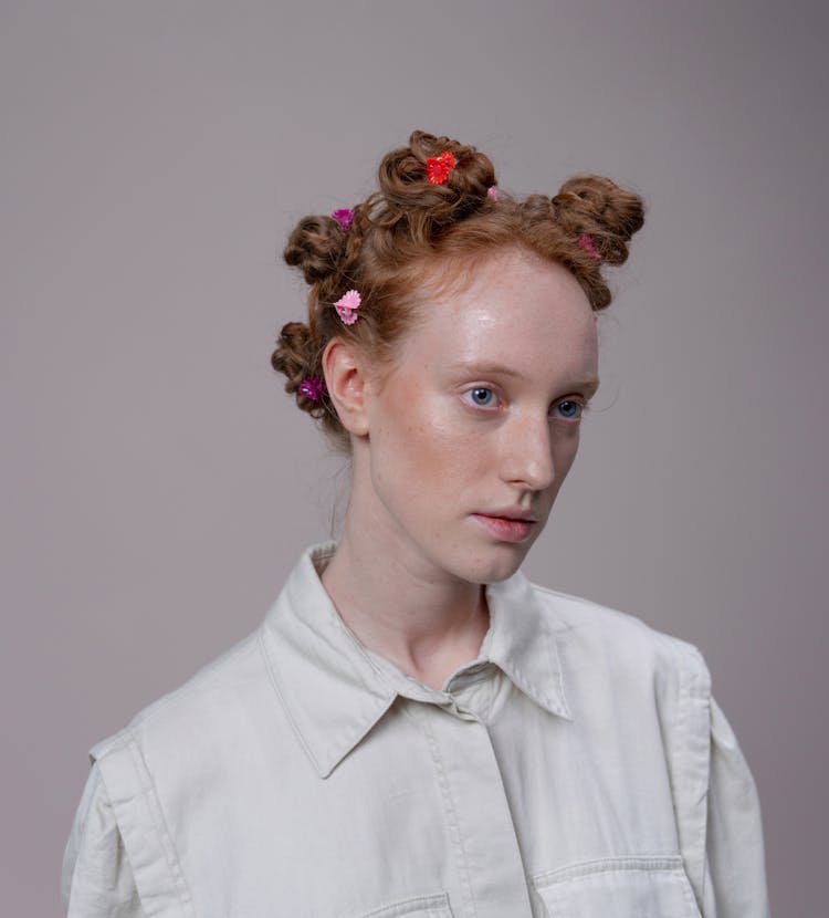 Portrait Of A Redhead Woman With Her Hair Up On Multiple Buns 