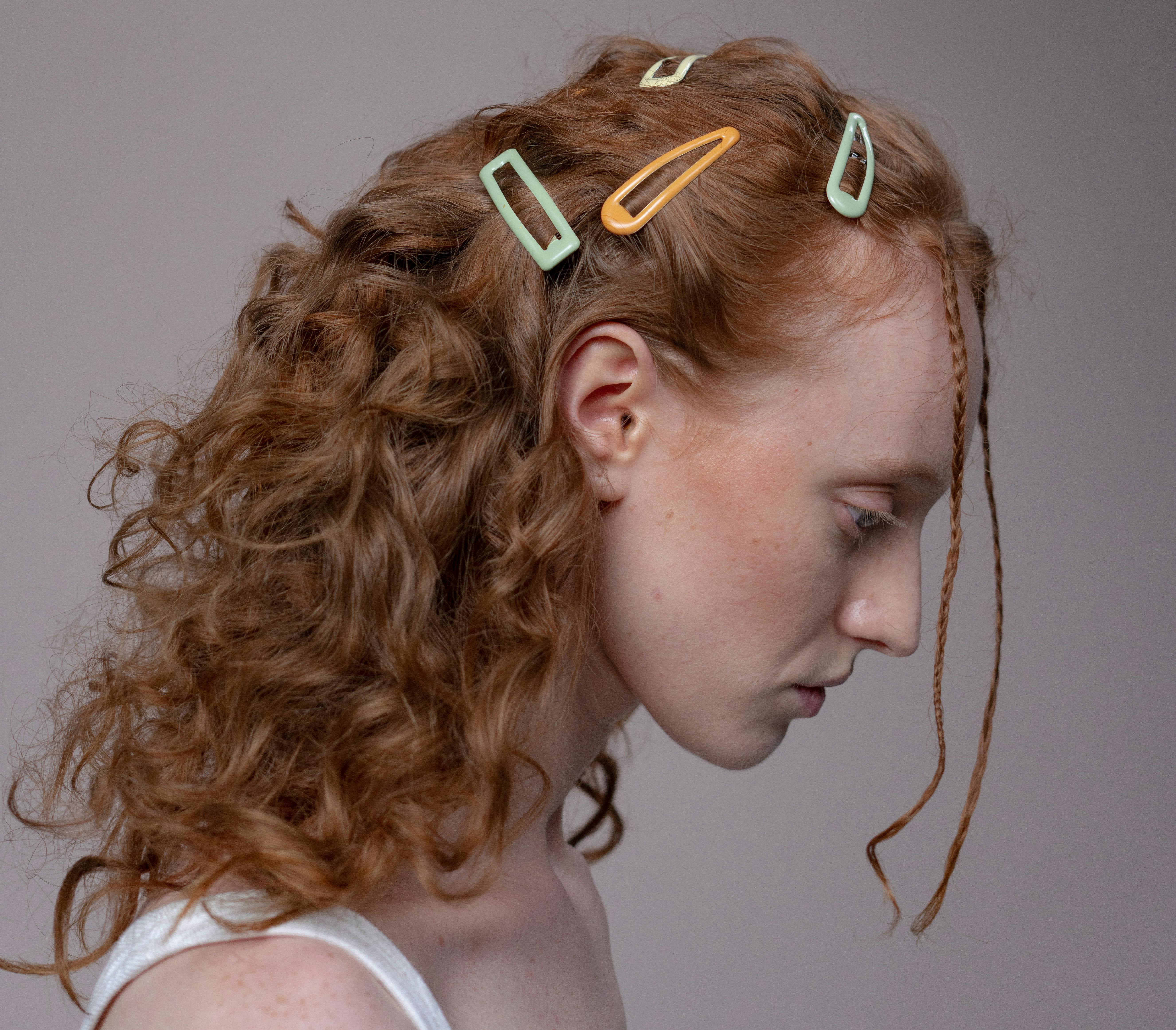 Free Close-Up Shot of a Woman with Hair Clips Stock Photo