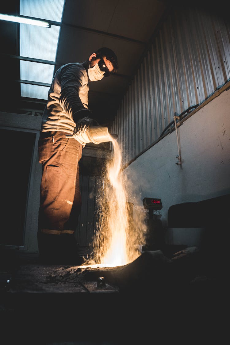 Man Pouring Melted Metal 