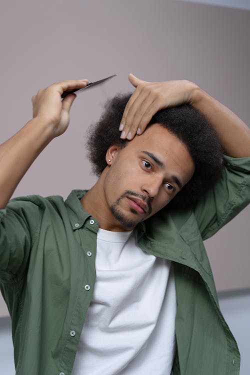 Man in Green Button Up Shirt Holding Black Pen