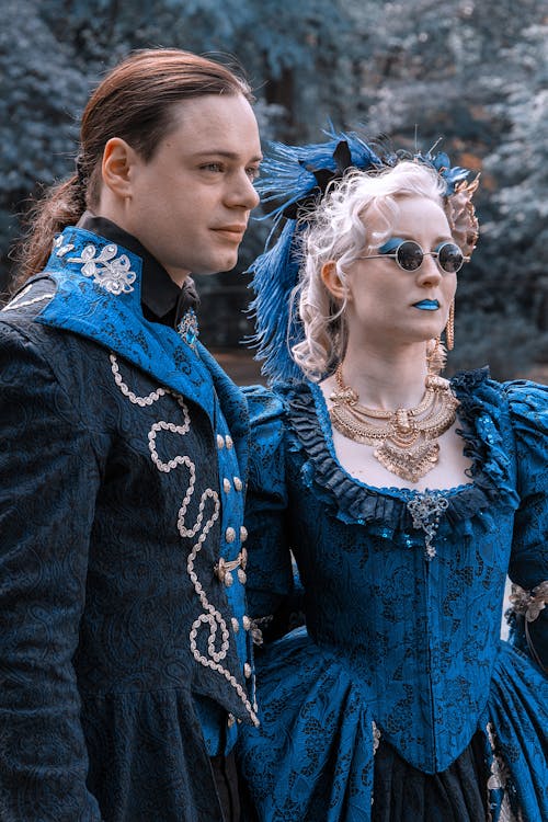 A Woman in Blue Medieval Gown Beside a Long Haired Man
